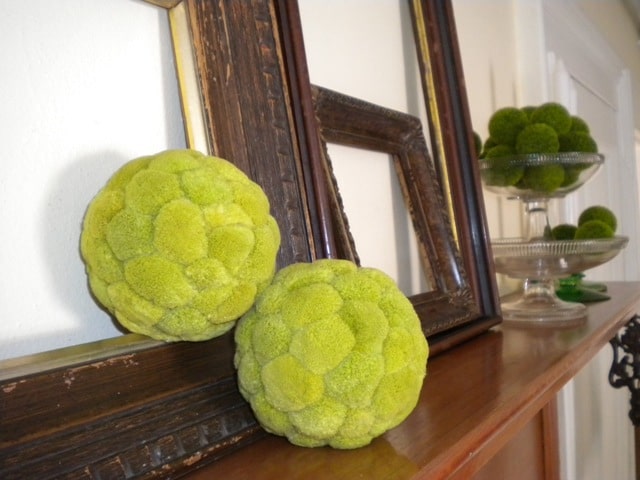 Soft green orbs add texture to the mantle decoration